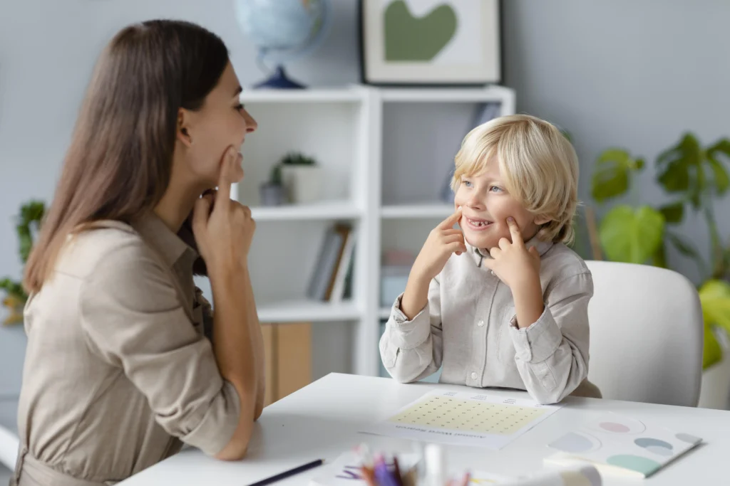 woman-doing-speech-therapy-with-little-blonde-boy